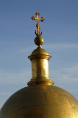 Golden Dome With An Orthodox Cross Gleaming Against A Clear Blue Sky In St. Petersburg, Symbolizing Religious Faith And Architecture.