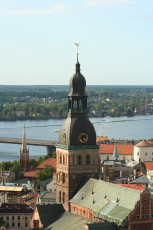 A Brick Building With A Clock Tower In Riga From Above.