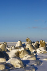 Rocks Covered In Snow At Daugavgrīva Beach In Winter.