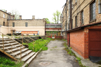 An Iļģuciems Alleyway With Stairs Leading To A Building.