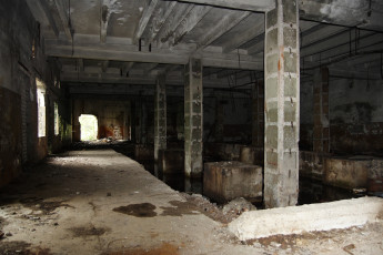 An Iļģuciems Room In An Abandoned Building With Concrete Floors And Pillars.