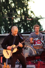 A Man Playing An Acoustic Guitar At Dzelzs Vilks Ielīgo '09 Festival.