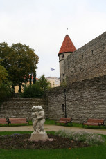 A Tallinn Wall With A Statue In Front Of It.