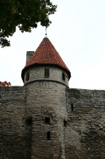 A Clock Adorns A Stone Wall In Tallinn.