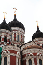A Tallinn Church With A Clock On Top.