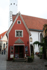 A Red Building With A Clock Tower In Tallinn.