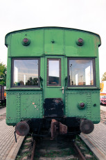 A Green Train Car Displayed At A Train Museum.